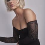 Blonde bob wig with layered style and side-swept bangs on a model.